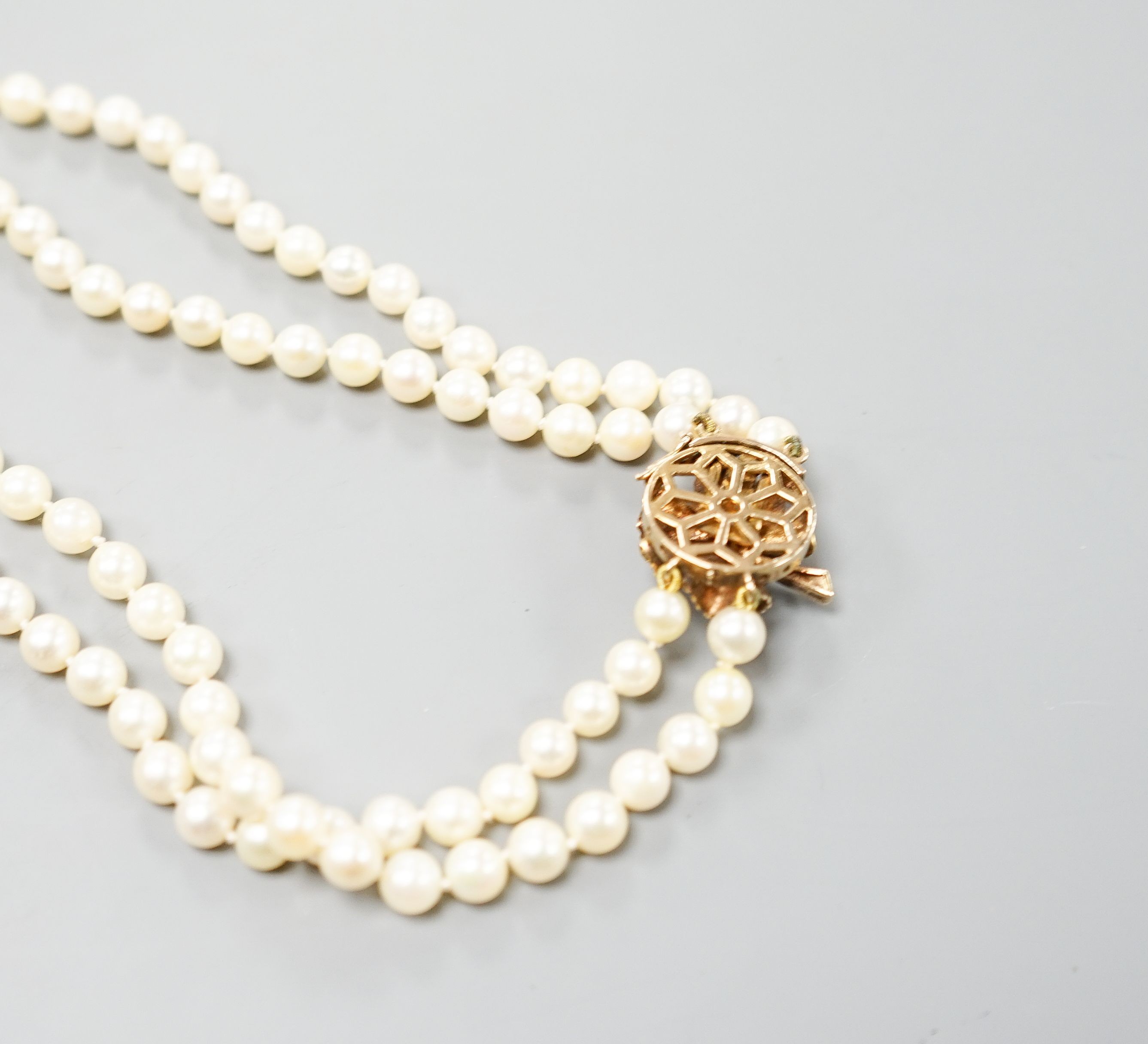 A double strand cultured pearl choker necklace, with cultured pearl set 9ct gold clasp, 38cm, with spare loose pearls.